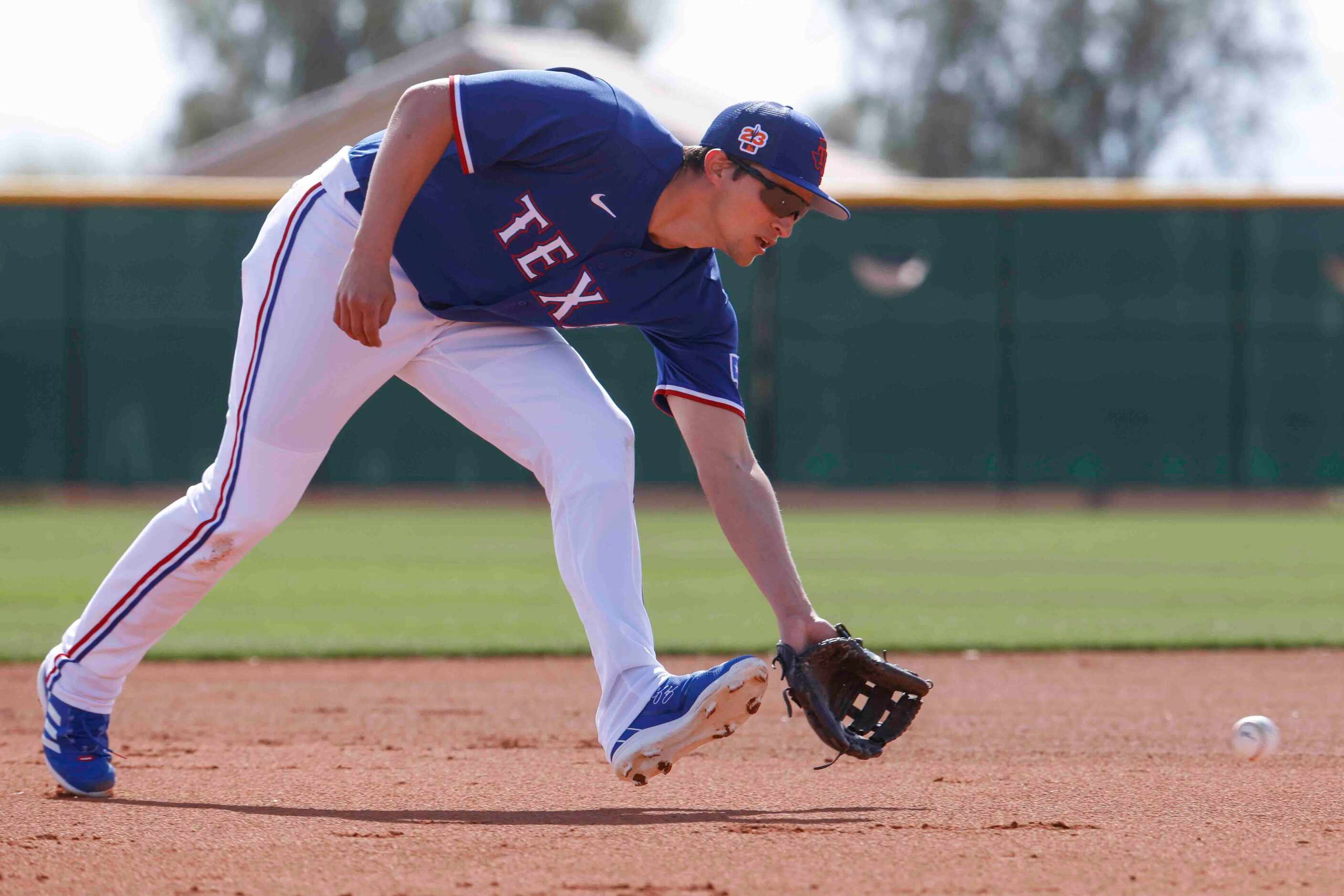 Texas Rangers shortstop Corey Seager fields a ball during a spring training workout at the...