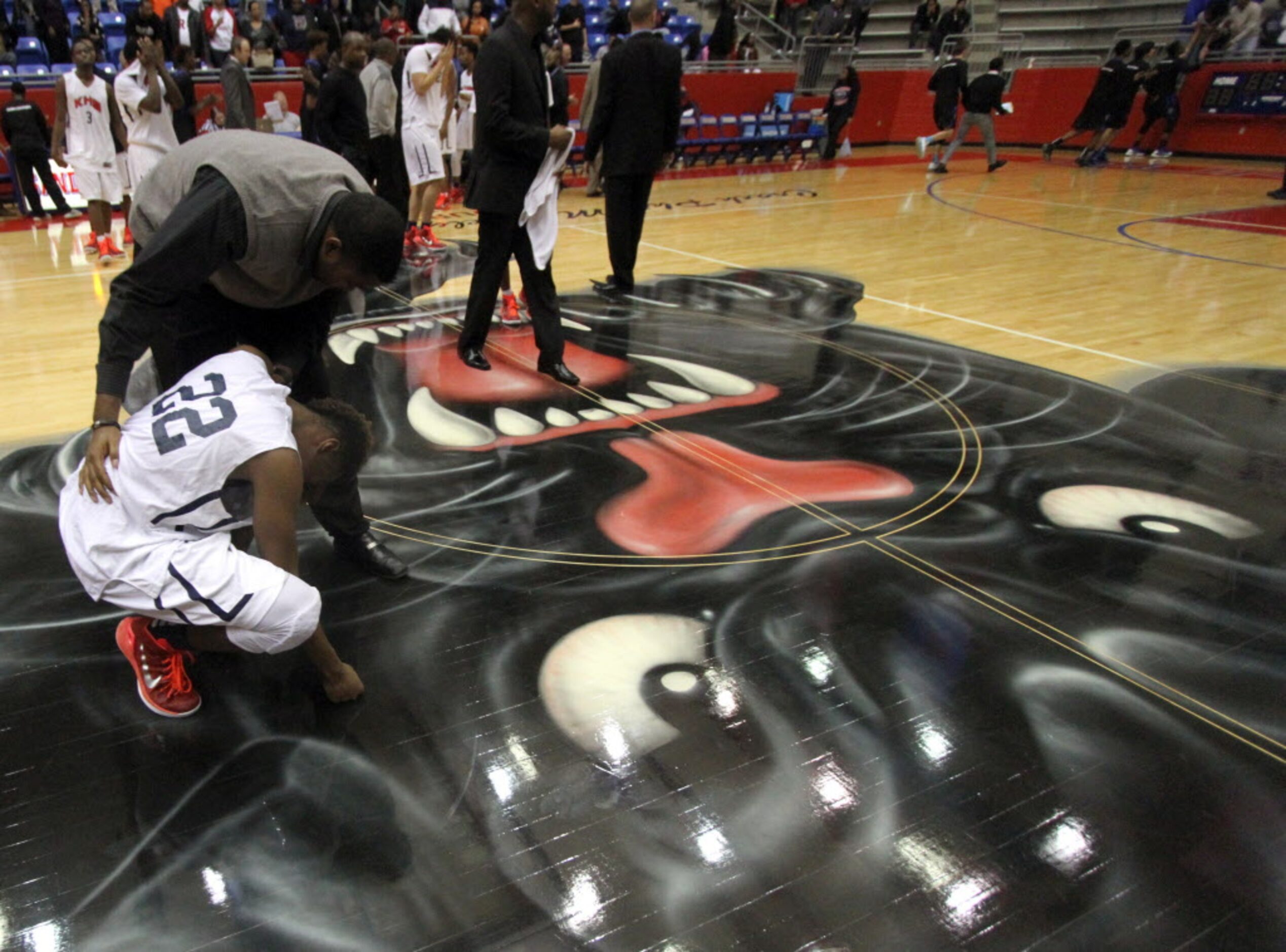 Dallas Kimball forward Kedarian Jones (22) is consoled by a coach following the Knights...