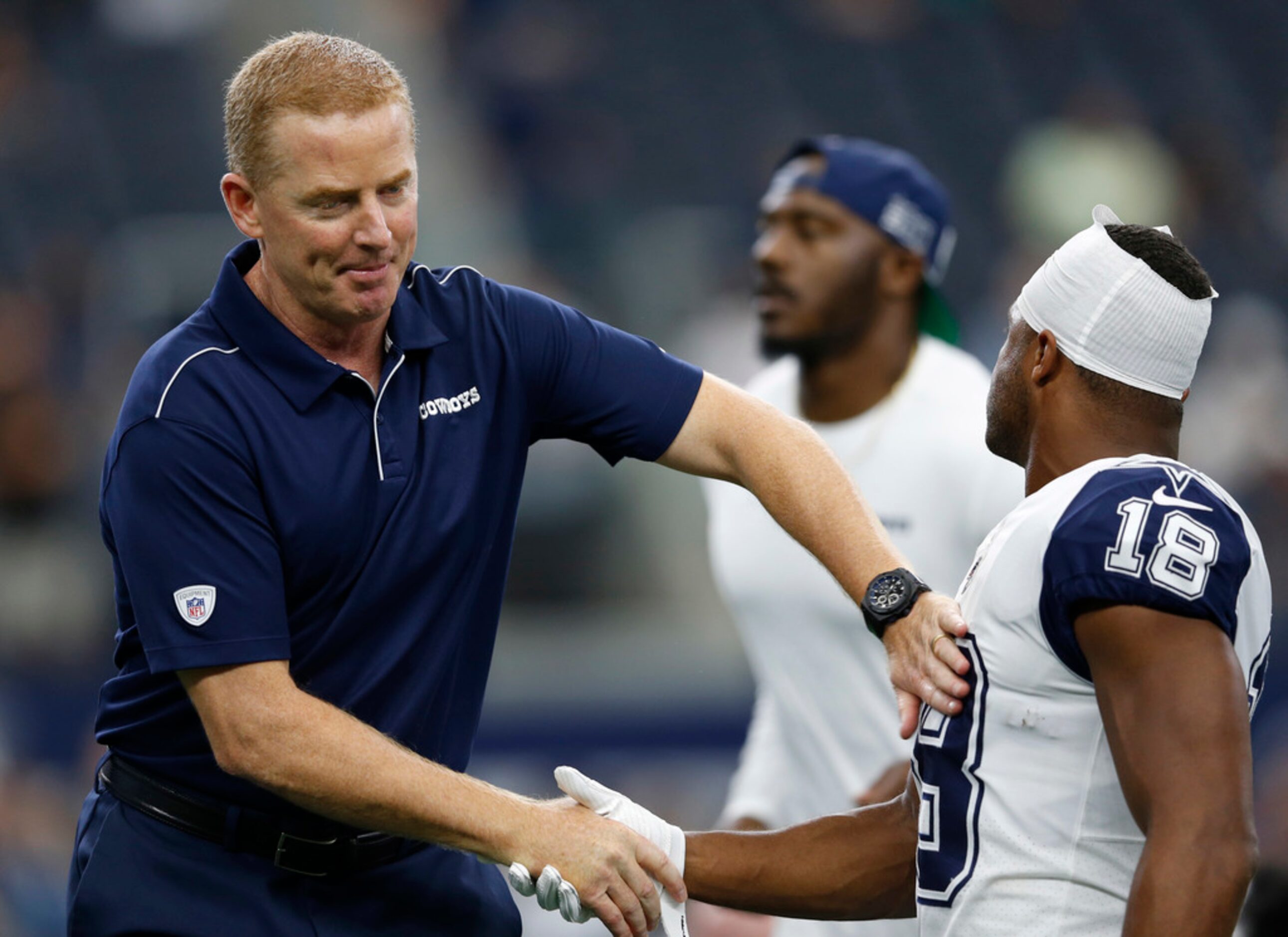 Dallas Cowboys head coach Jason Garrett greets Dallas Cowboys wide receiver Randall Cobb...