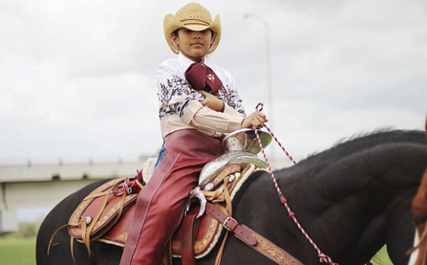 Madeleine Guerra, 9, likes to dress in full cowboy gear when she rides horses with her...