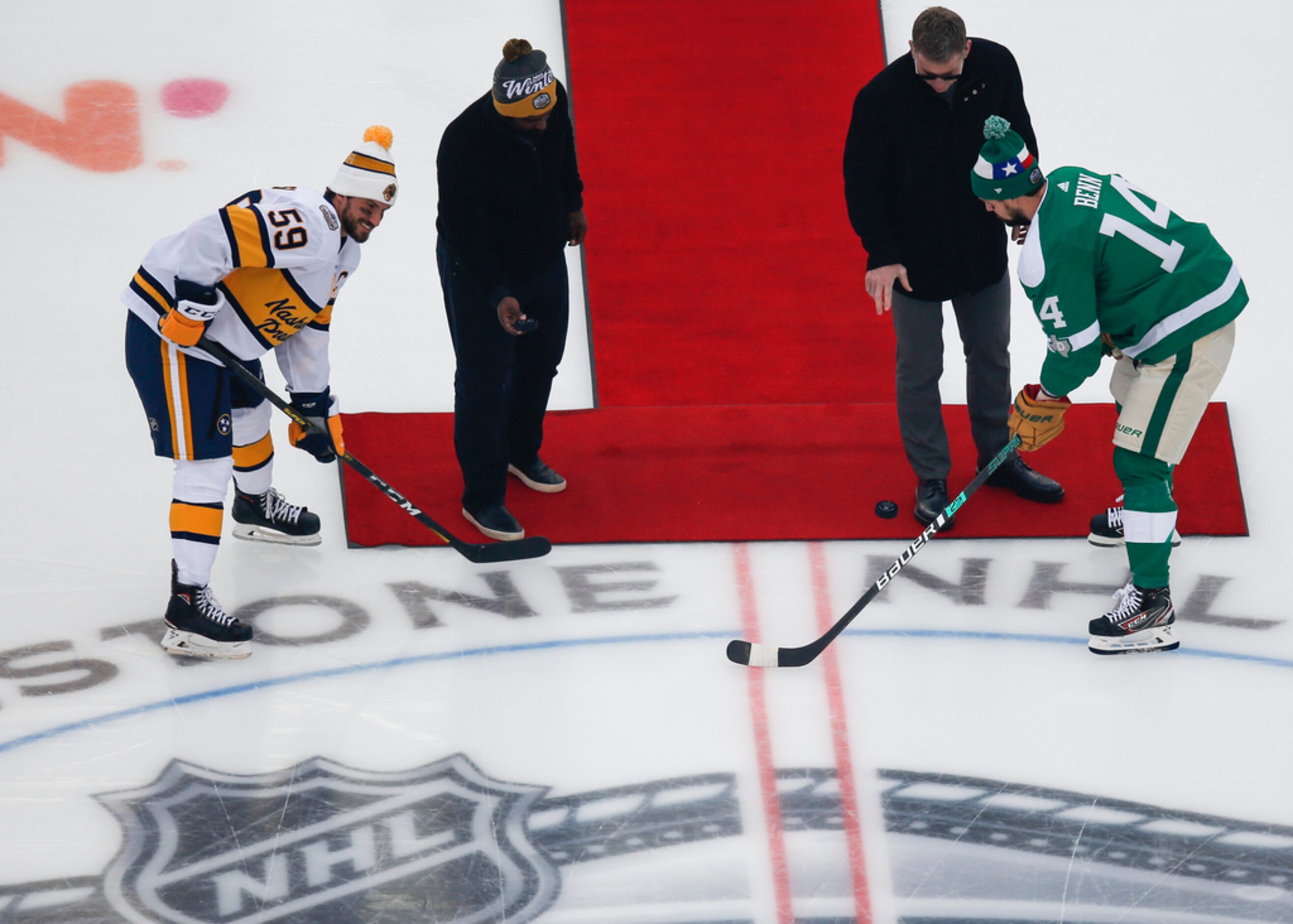 Ricky Williams, second from left, and Troy Aikman, third from left, drop pucks for Nashville...