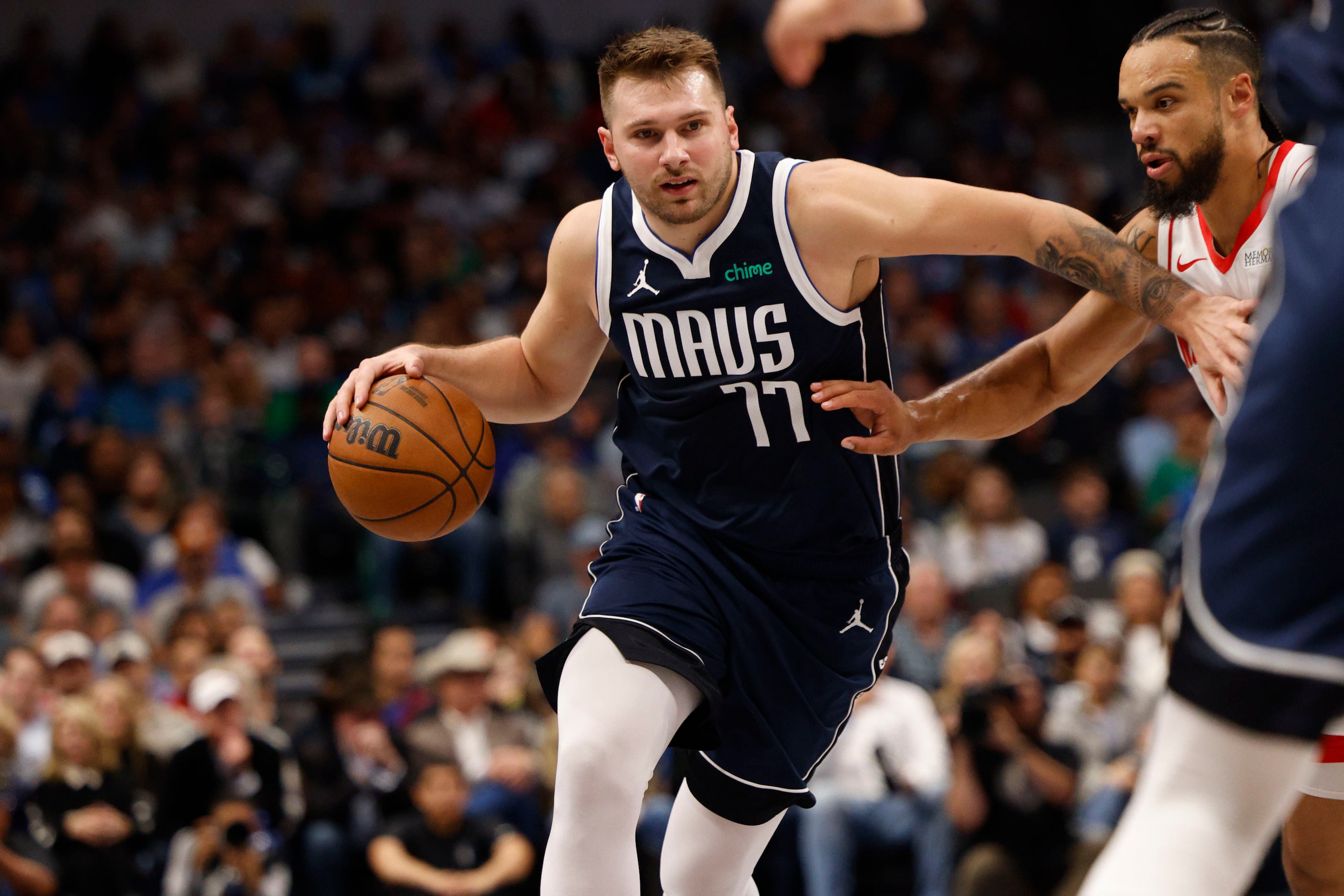 Dallas Mavericks guard Luka Doncic (77) tries to drive past Houston Rockets forward Dillon...