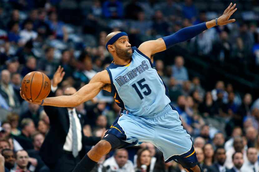 Memphis Grizzlies guard Vince Carter (15) leaps in the air  over the half court line to save...
