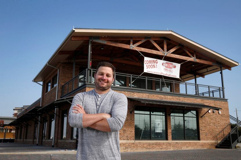 CEO Curtis Croft stands in front of Main Street Food Hall, which is under construction and...