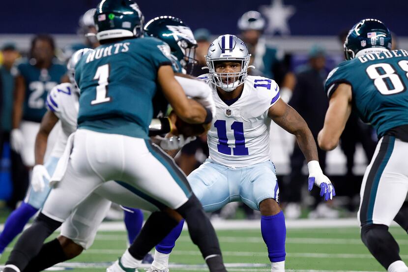 Dallas Cowboys linebacker Micah Parsons (11) looks to cover a fake handoff by Philadelphia...