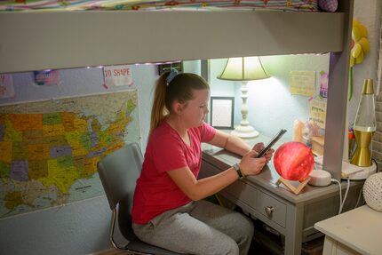 Rachel Howe reads at her bedroom desk after receiving her COVID-19 shot.