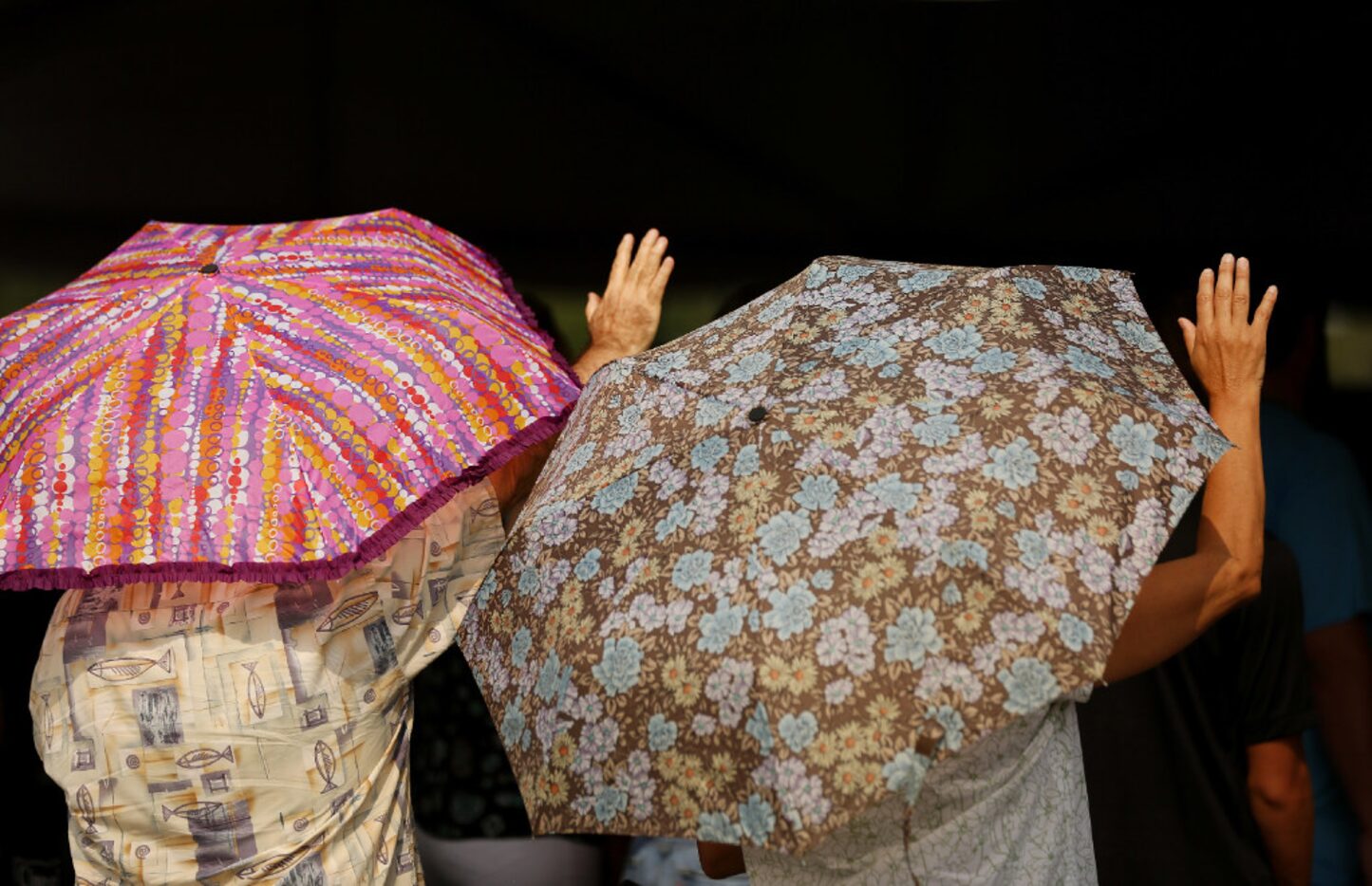 Worshippers brought their own shade to the church service at First Baptist Humble on Sunday.