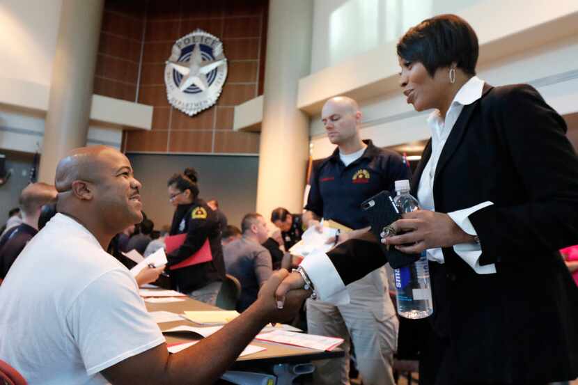 Dallas Police Chief U. Renee Hall greets applicant Antwain Robinson from Arkansas at the...