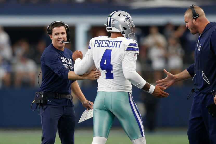 Dallas Cowboys offensive coordinator Kellen Moore celebrates with Dallas Cowboys quarterback...