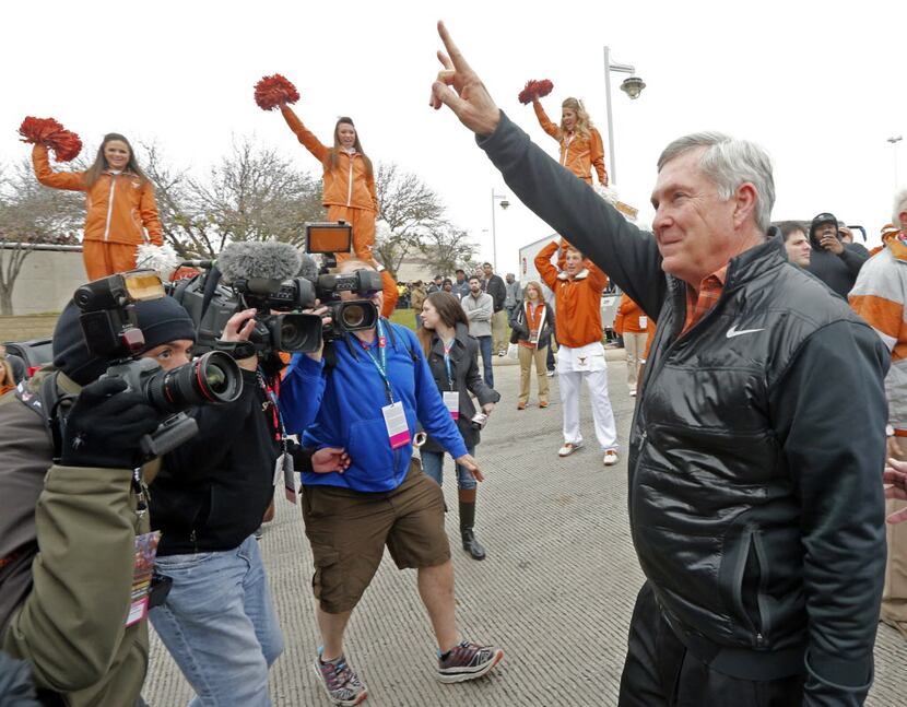 Texas Longhorns head coach Mack Brown greets fans as he enters the Alamodome prior to the...