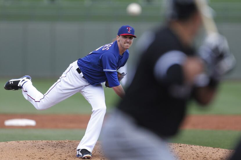 Texas pitcher Tanner Scheppers fires a third-inning pitch during the Chicago White Sox vs....