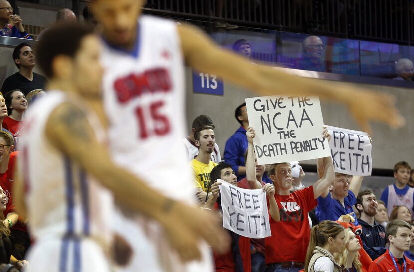 SMU Mustangs hold signs saying "Give the NCAA the Death Penalty" and "Free Keith" --...