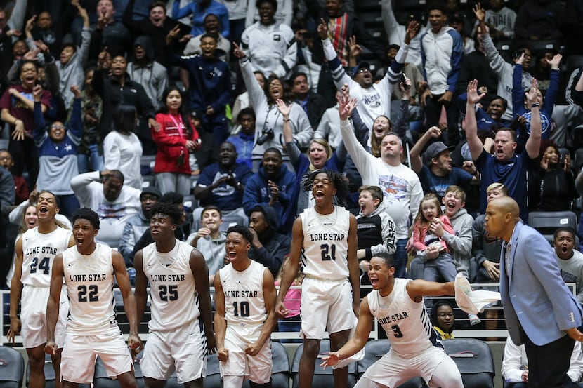 The Frisco Lone Star bench erupts in celebration during the second half a boys basketball...