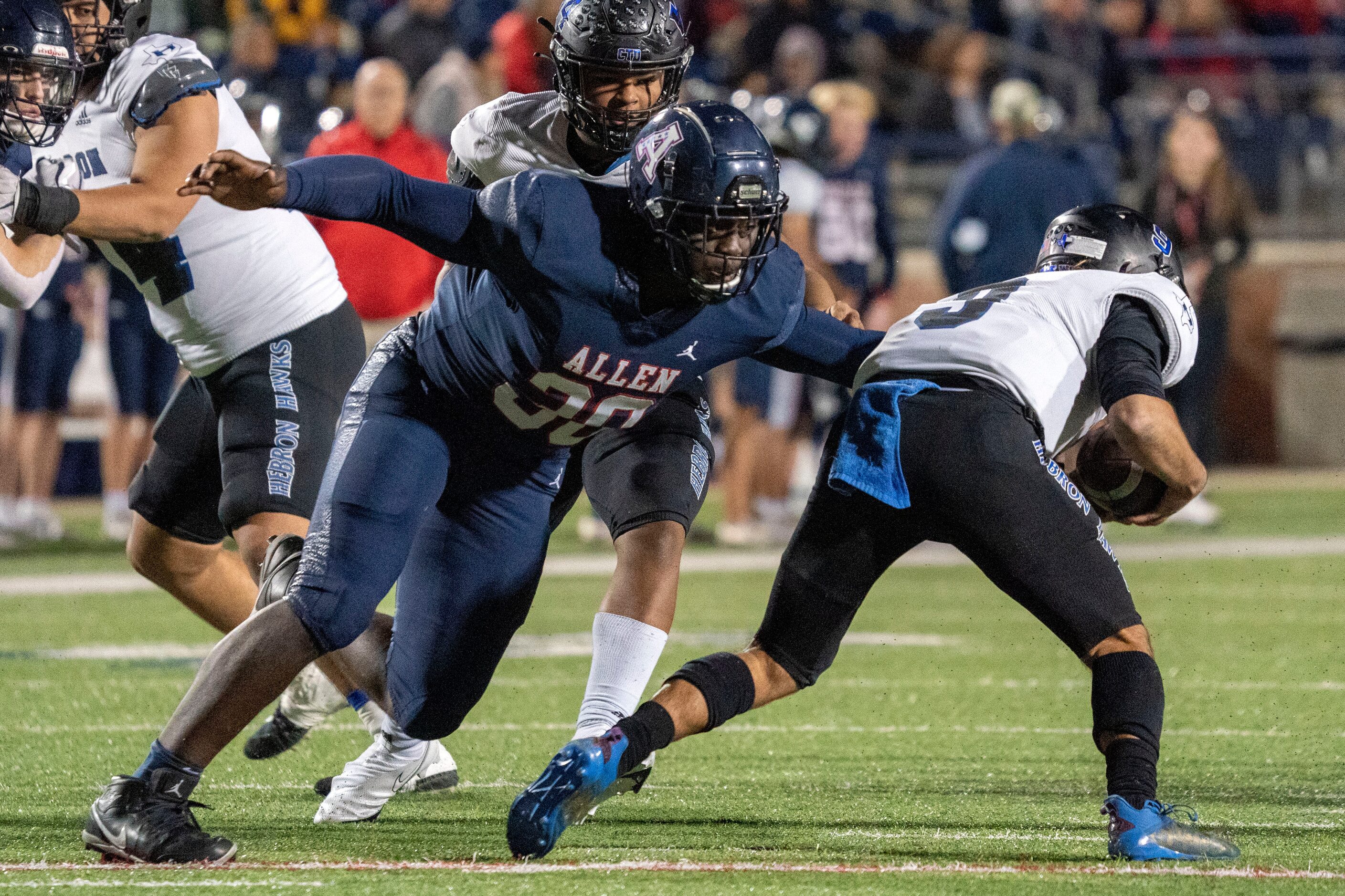 Allen junior defensive lineman DJ Hicks (30) closes in on Hebron quarterback Jacob Buniff...