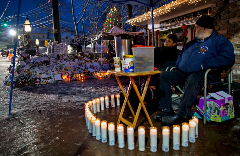 Joanne and Bill Brunetti of Newtown, Conn., part of a group monitoring memorials around the...