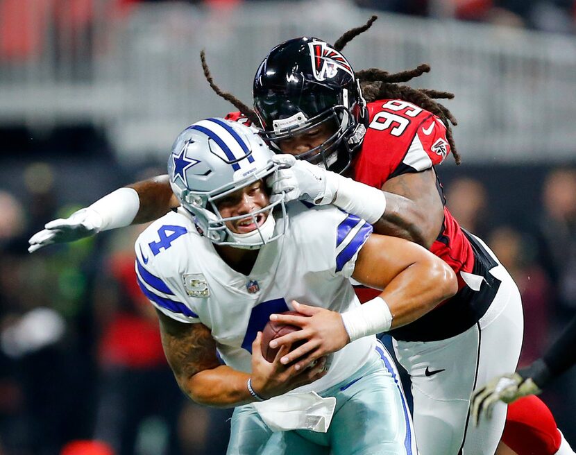 Dallas Cowboys quarterback Dak Prescott (4) is sacked by Atlanta Falcons defensive end...