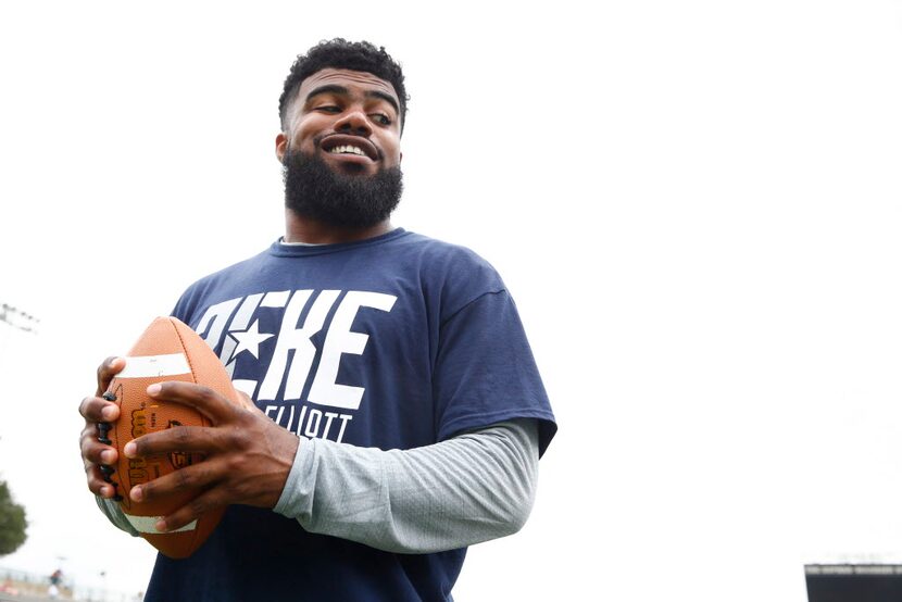 Ezekiel Elliott smiles at a kid during the Ezekiel Elliott's Football ProCamp at Grand...