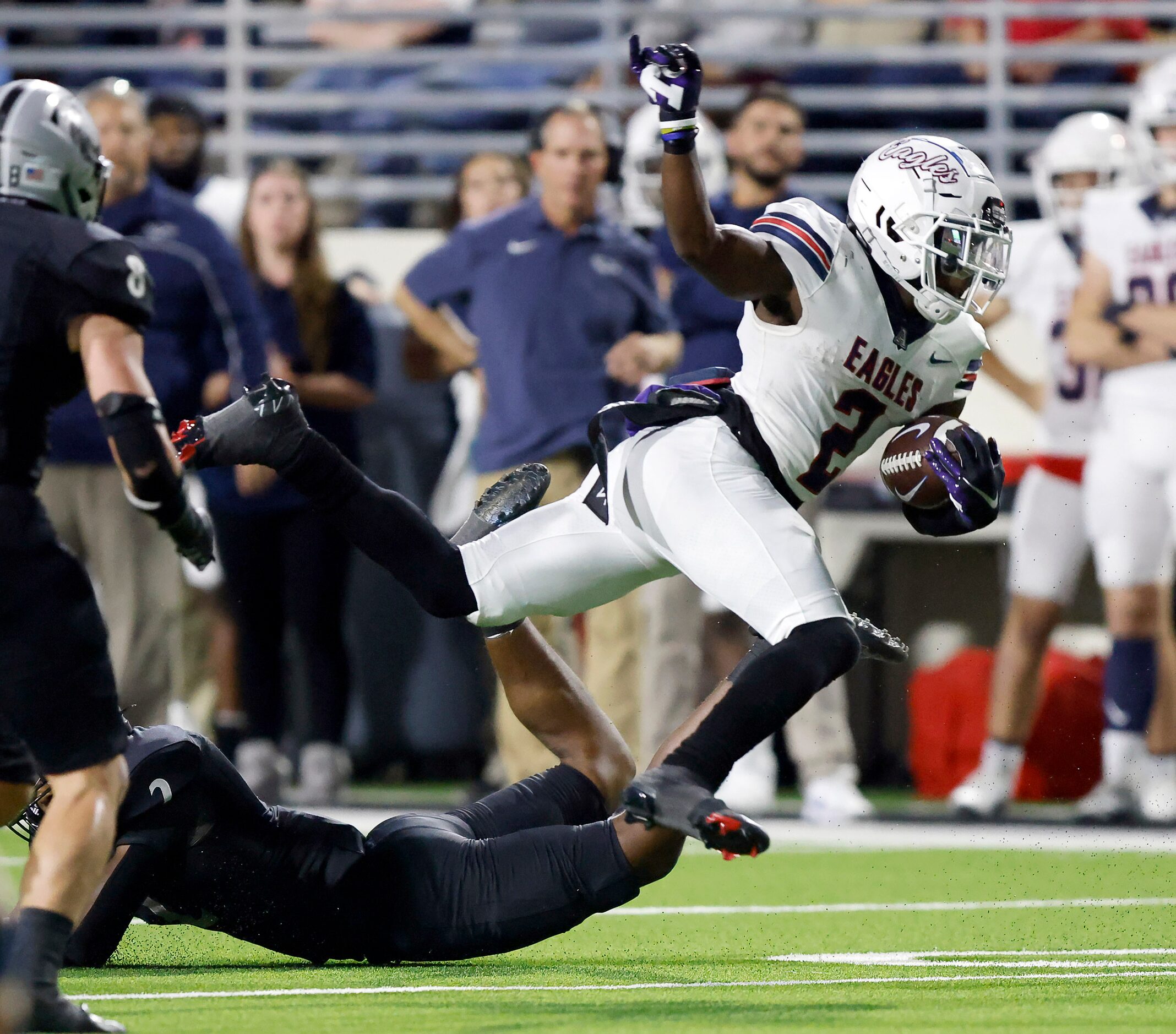 Allen wide receiver Kayvion Sibley (2) flies through the air after having his legs taken out...