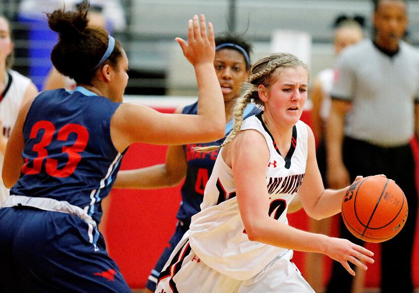 Colleyville Heritage guard Bryn Gerlich (10) drives past Grapevine forward Jessi Prater (33)...