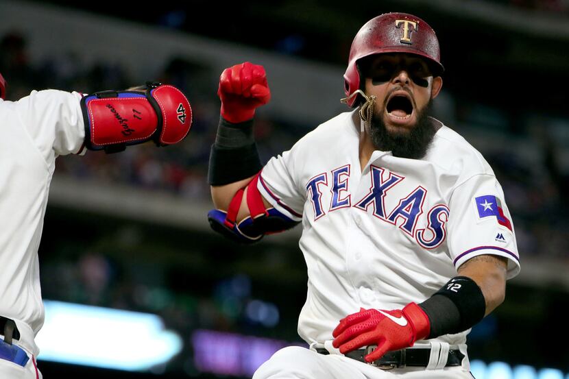 ARLINGTON, TEXAS - JUNE 18: Rougned Odor #12 of the Texas Rangers celebrates after hitting a...