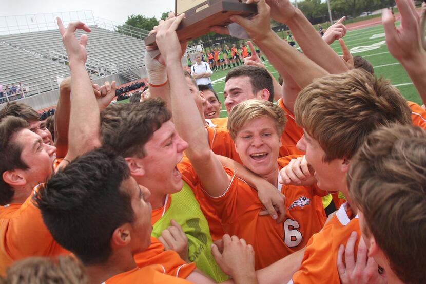 The Frisco Wakeland soccer team hold up their trophy in celebration after defeating Frisco...