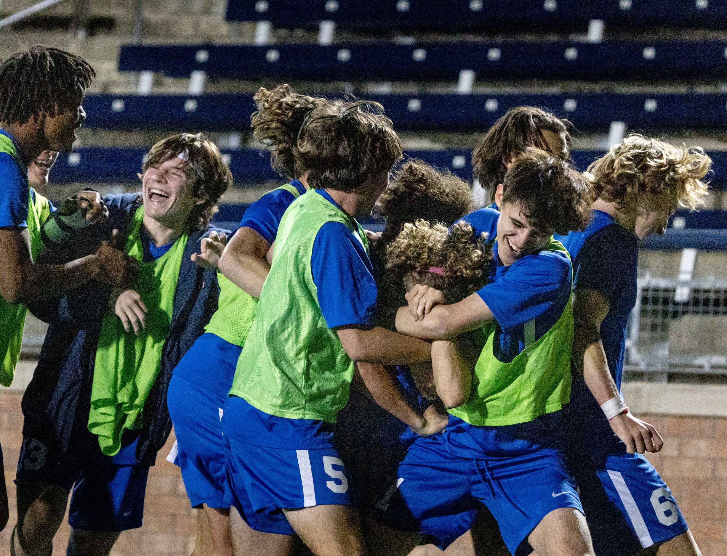 Allen High School teammates grab Matthew Sanchez and celebrate with him after he scoeres in...