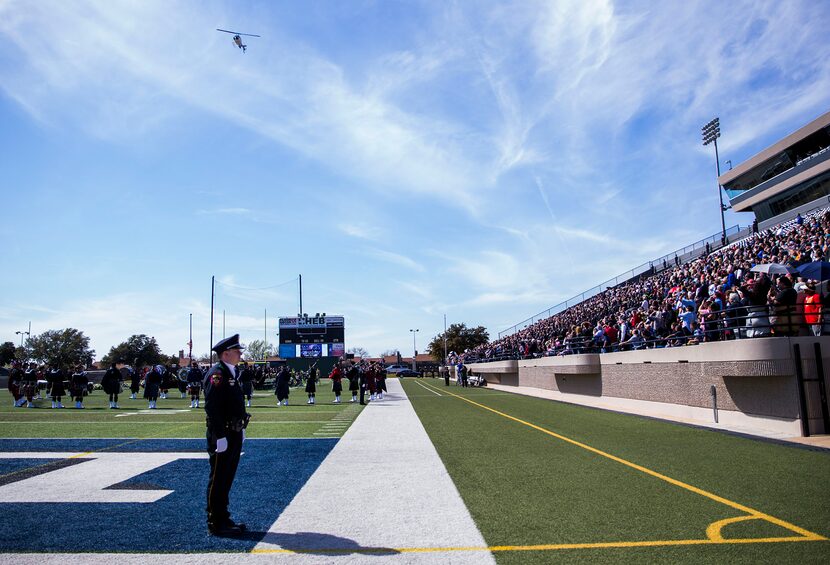  A helicopter flies over a memorial service for Euless police officer David Hofer.