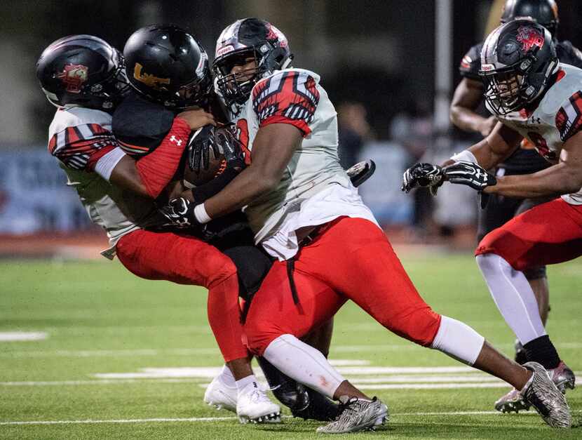 Mansfield Legacy defensive back Jalon Catalon (left) and defensive lineman Enoch Jackson...