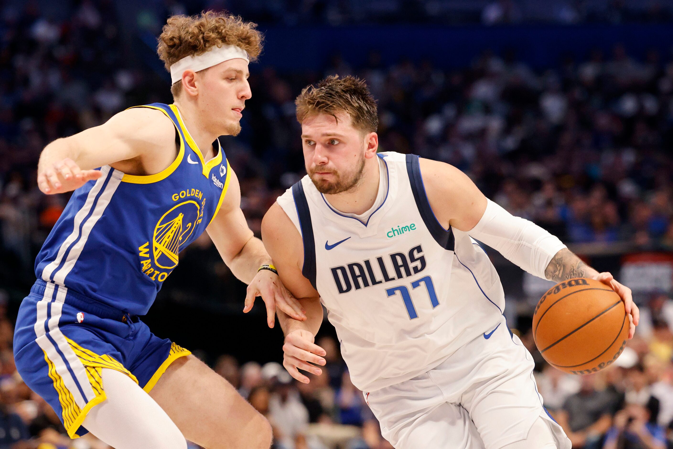 Dallas Mavericks guard Luka Doncic (77) tries to drive past Golden State Warriors guard...