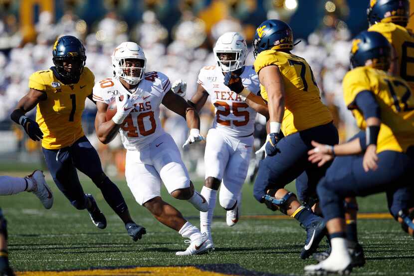 MORGANTOWN, WV - OCTOBER 05: Ayodele Adeoye #40 of the Texas Longhorns runs with the ball...