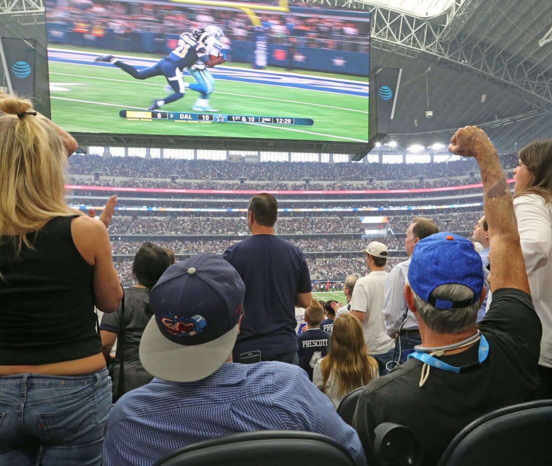 Pete Lane, who is visually impaired, cheers for a big play from the stands.