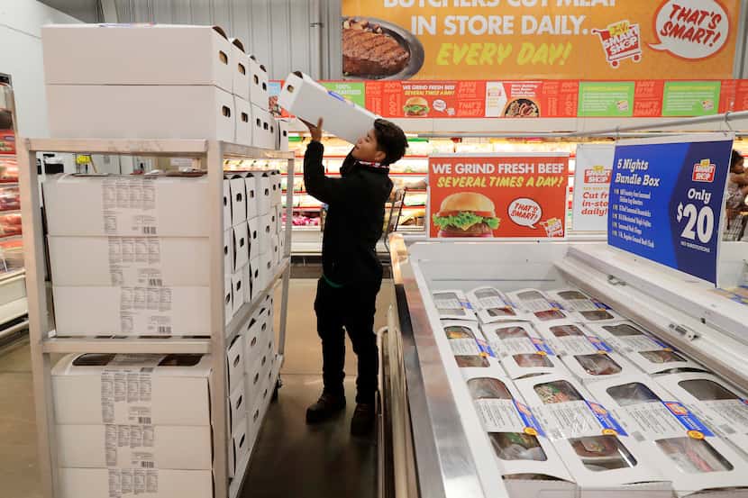 Joe V's Smart Shop employee Isaac Briceno stocks Bundle Boxes into refrigerated cases at the...