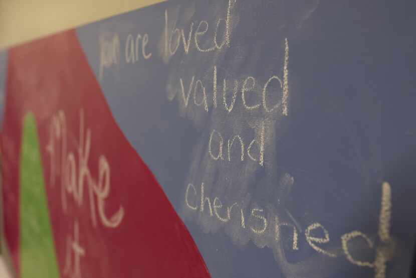 “You are loved valued and cherished” is written on a board in the room of the youth resource...