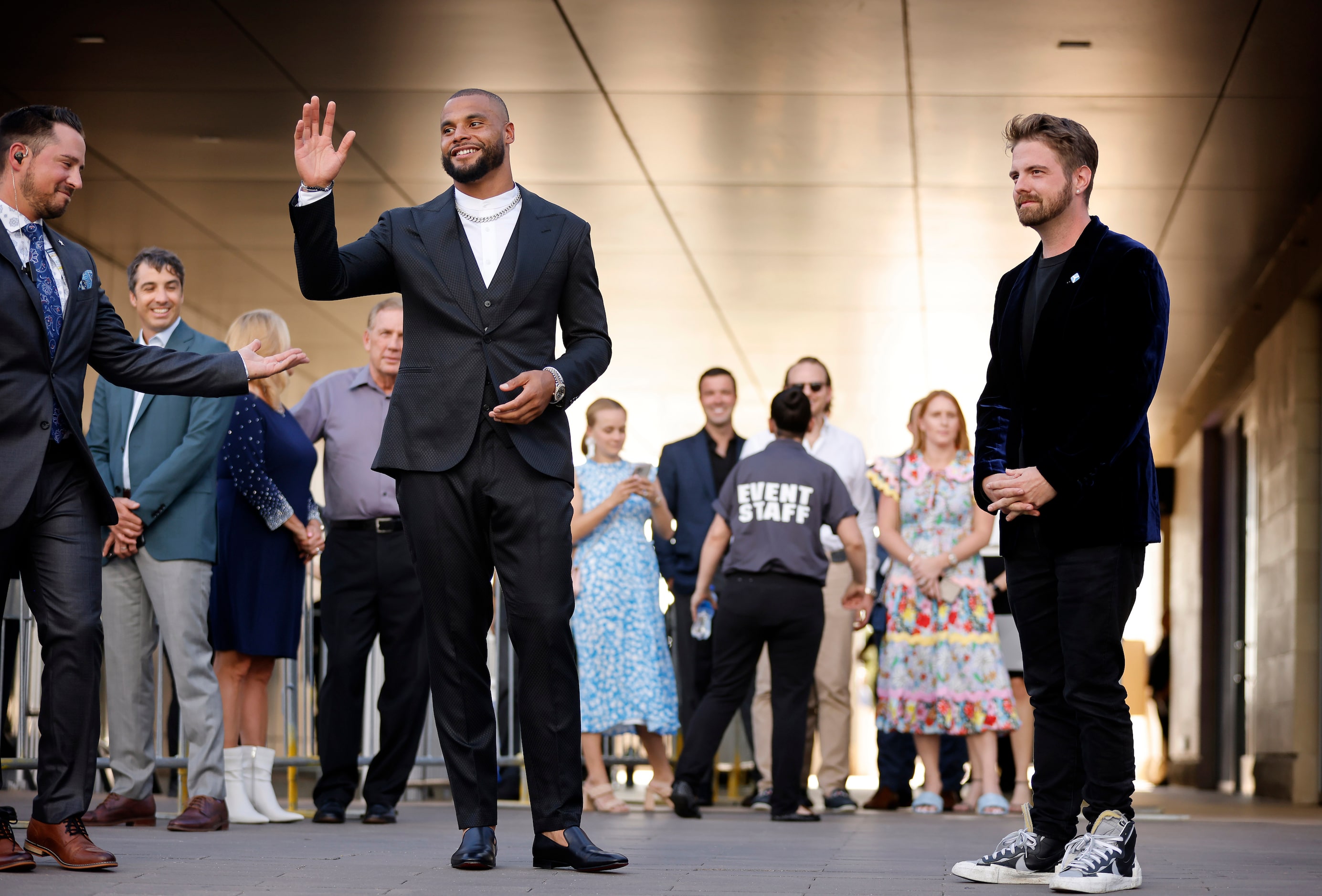 Dallas Cowboys quarterback Dak Prescott waves to fans as he arrives to the Dallas Cowboys...