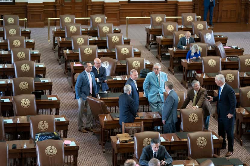 Republican Texas House members mill about the floor on Wednesday. To leave the chamber,...