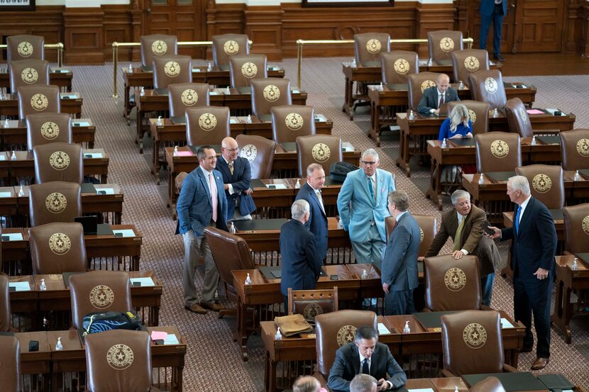 Republican Texas House members mill about the floor on Wednesday. To leave the chamber,...