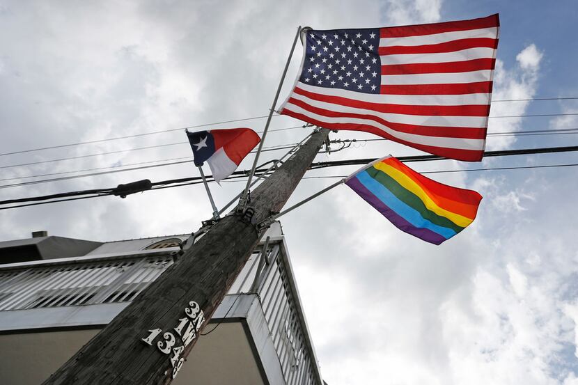 An LGBT flag flies at the intersection of Cedar Springs Road and Throckmorton Street in Dallas.