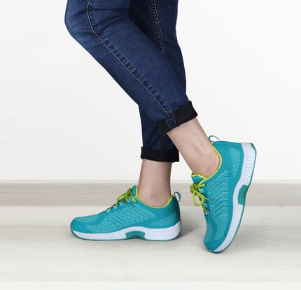 Closeup image of woman wearing turquoise Orthofeet walking shoes