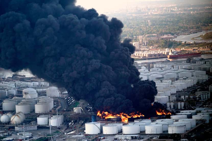 A plume of smoke rises from a petrochemical fire at the Intercontinental Terminals Company...