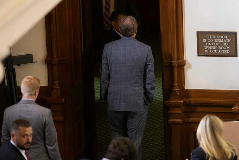 Texas Attorney General Ken Paxton heads out of the Senate chamber after the Senate was...