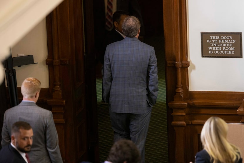 Texas Attorney General Ken Paxton heads out of the Senate chamber after the Senate was...