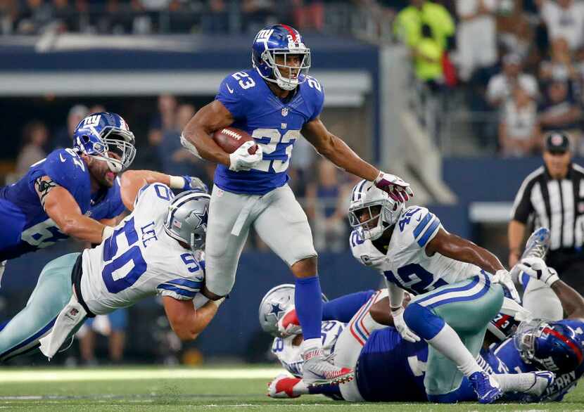 New York Giants running back Rashad Jennings (23) is tackled by Dallas Cowboys outside...