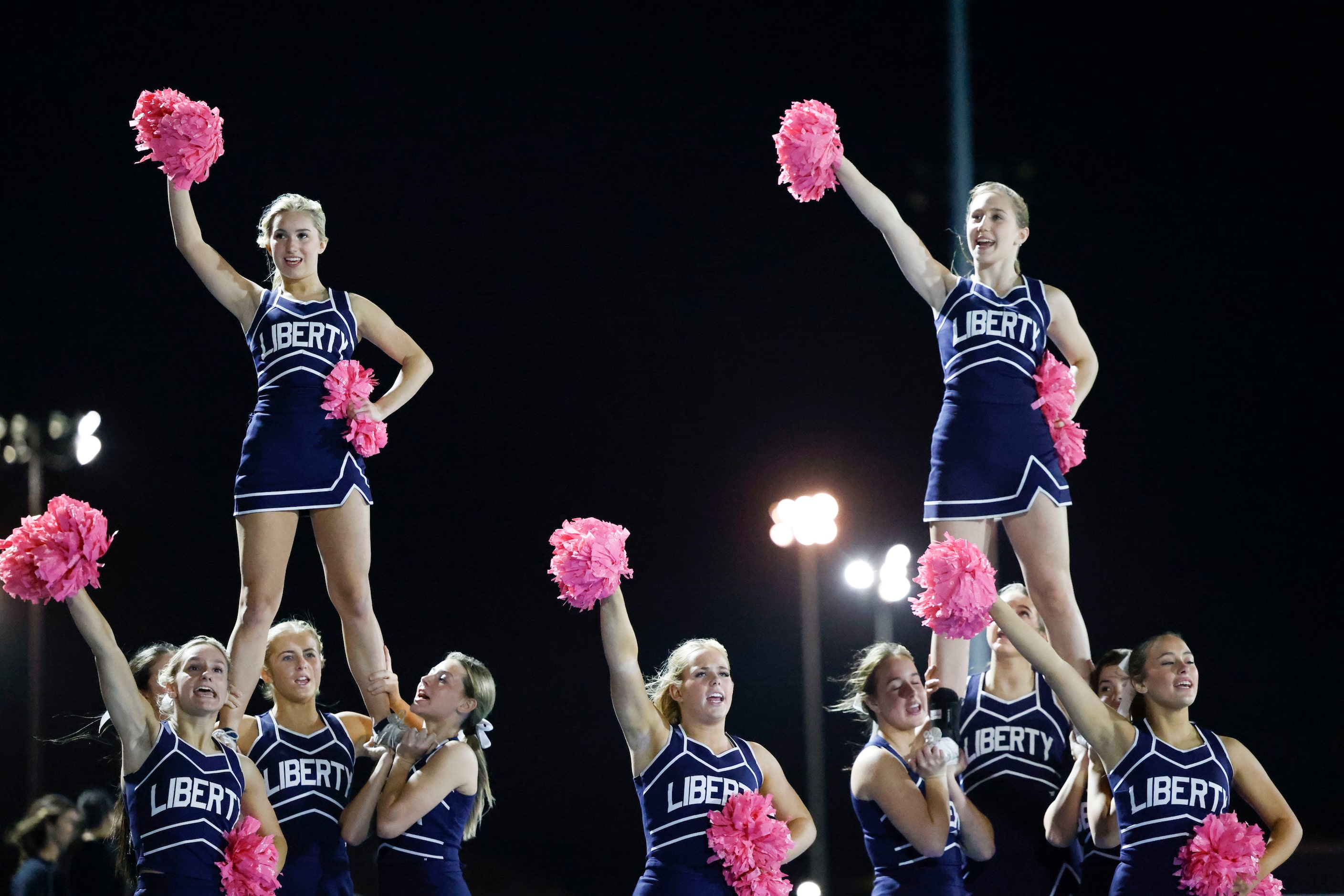 Liberty Christian School cheer leaders perform during an outdoor volleyball game against...