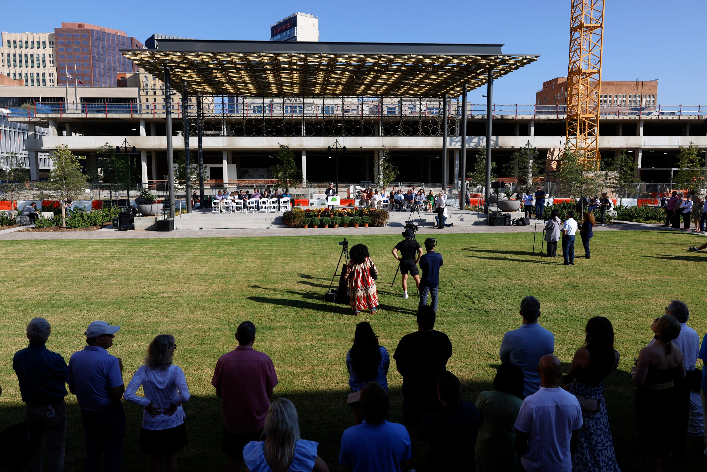 Attendees listen to Dallas Council Member Jesse Moreno  during the opening ceremony of...