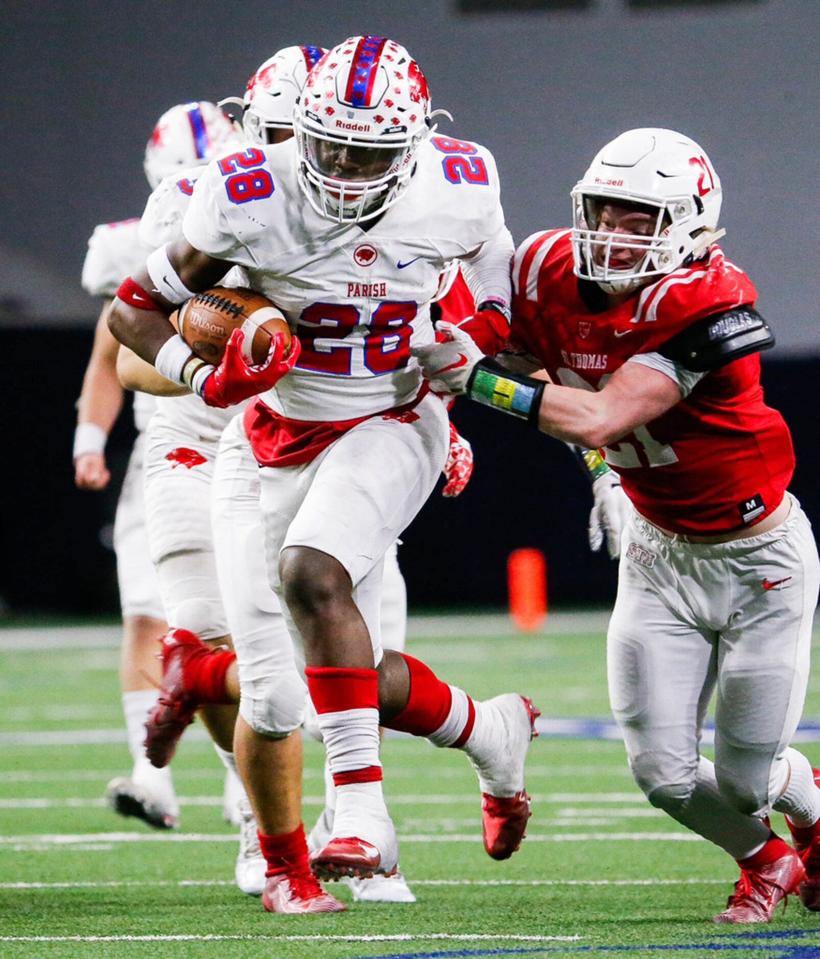 Parish Episcopal running back Cauren Lynch (28) is tackled by Houston St. ThomasÃs Charlie...