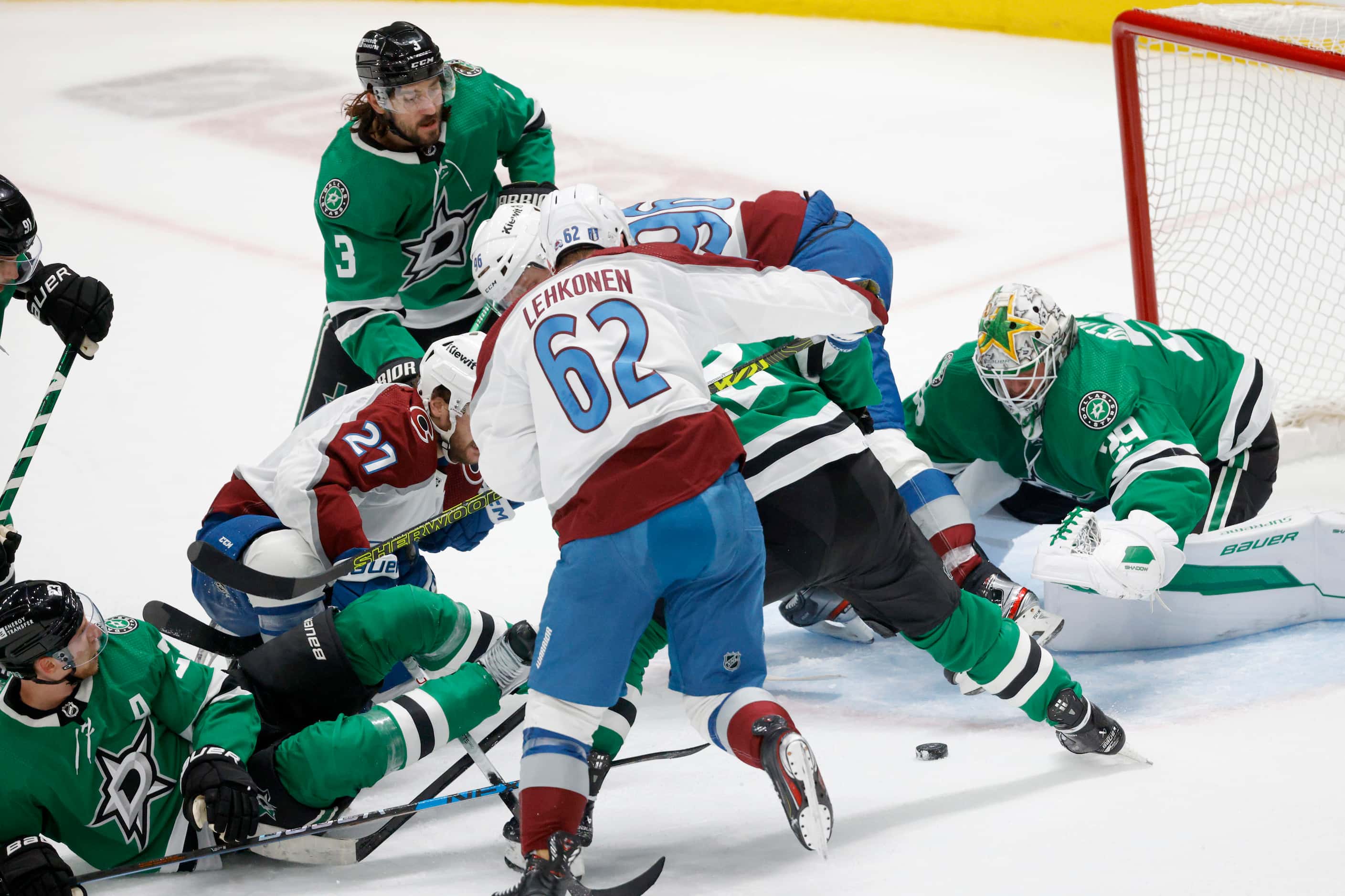 Dallas Stars players and Colorado Avalanche players compete for the puck during the first...
