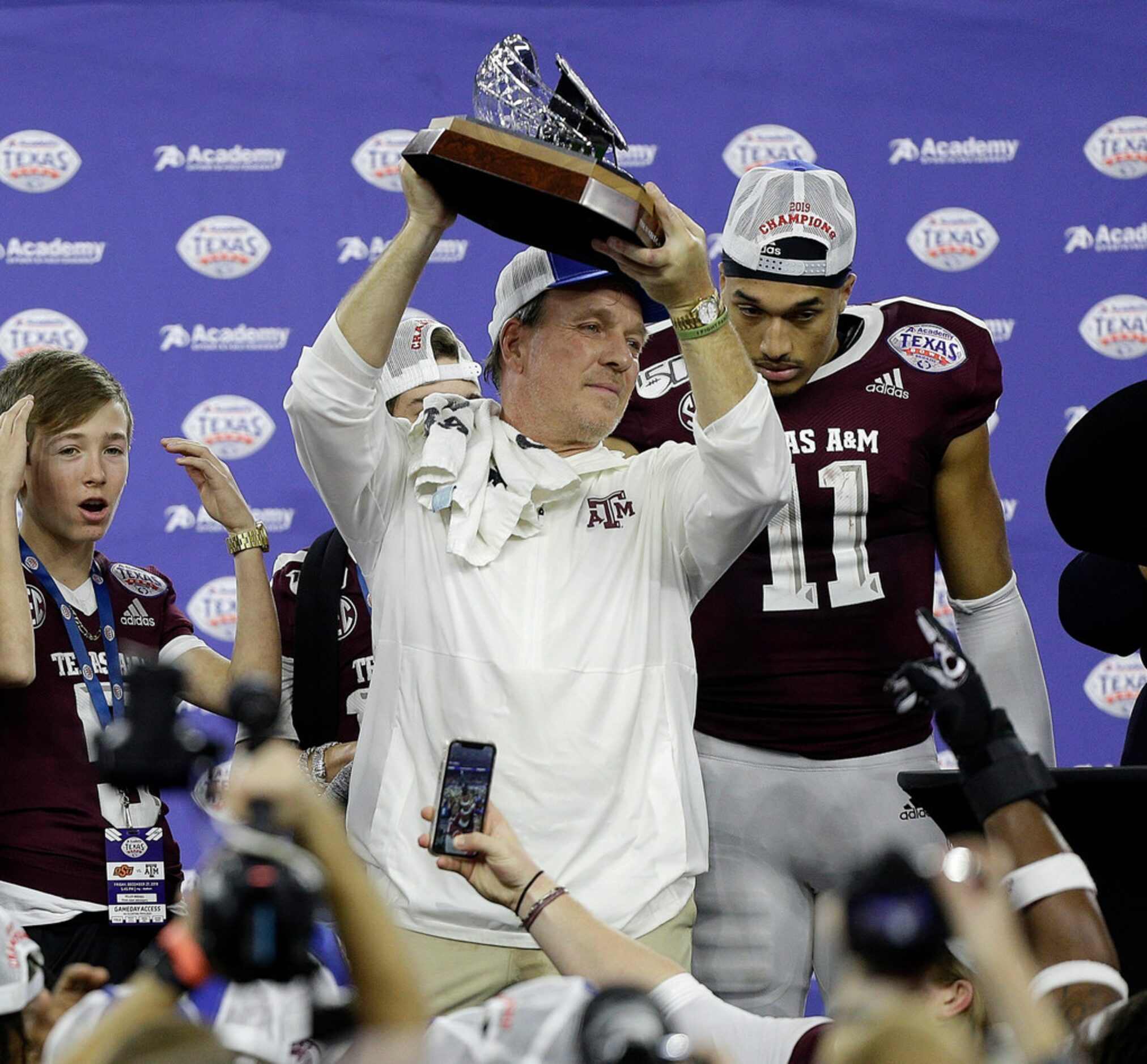 HOUSTON, TEXAS - DECEMBER 27: Head coach Jimbo Fisher of the Texas A&M Aggies holds up the...