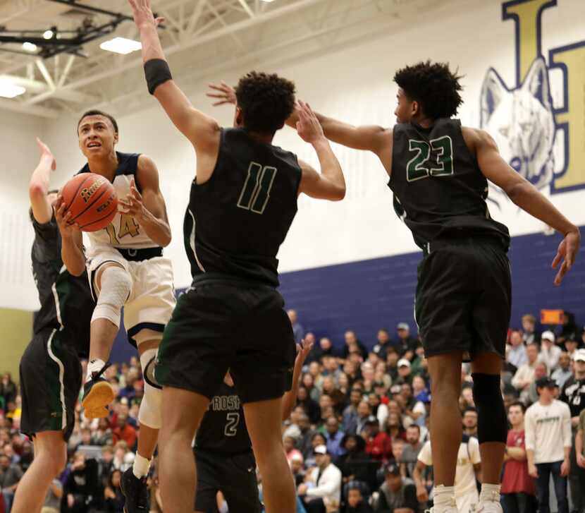 Little Elm player #14, RJ Hampton, attempts to score as Prosper players #11, Josh Davis, and...