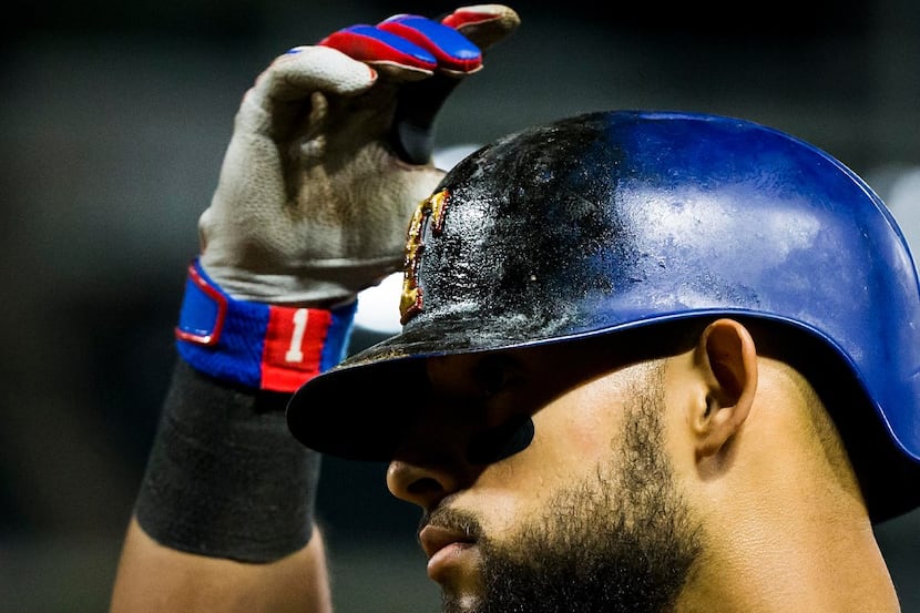 Texas Rangers second baseman Rougned Odor adjusts his pine tar covered batting helmet before...