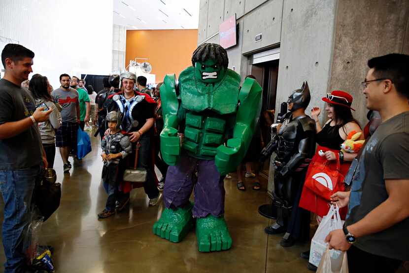 John Stephenson moves through crowds in a large Hulk costume during the Dallas Comic Con:...